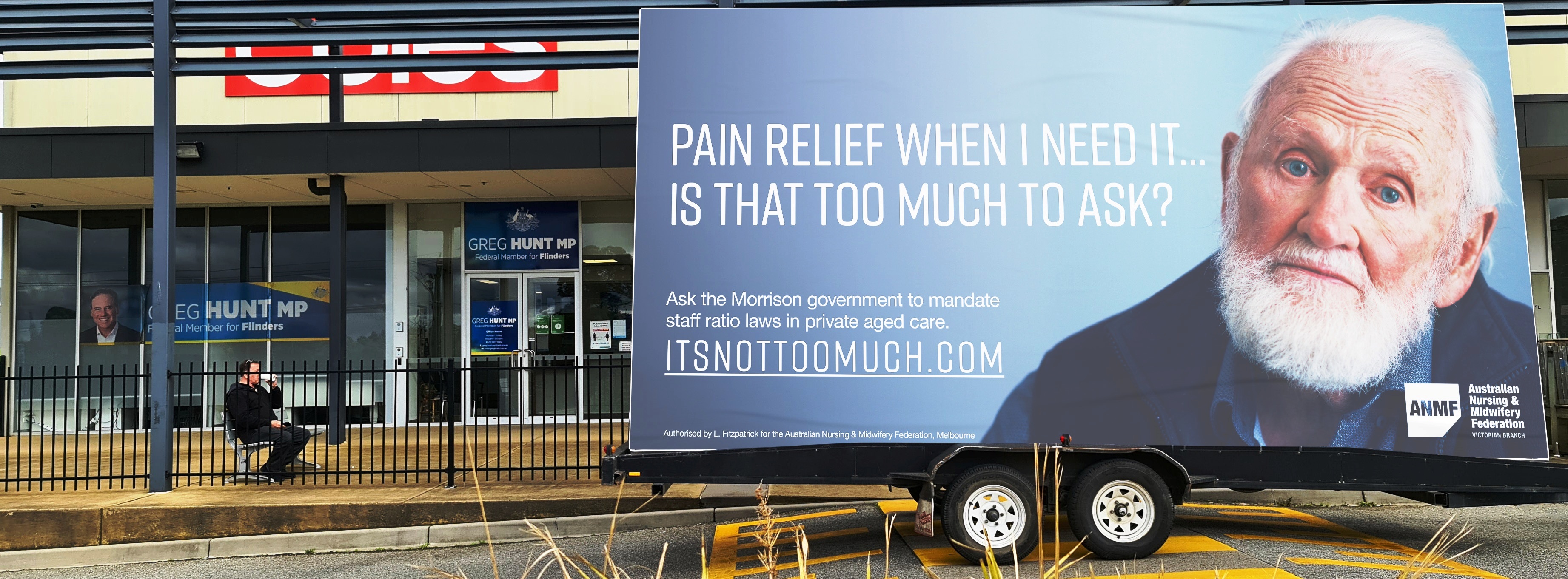 The ‘It’s not too much’ campaign billboard outside Federal Health and Aged Care Minister Greg Hunt’s Flinders electorate office in Sommerville.